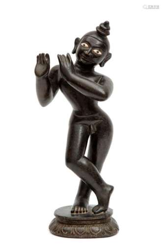A black stone figure of Krishna