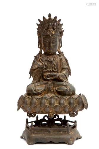 A Chinese bronze figure of Guanyin on a lotus stan…