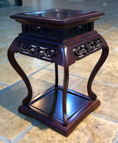 A RED WOOD TABLE CARVED WITH PATTERN