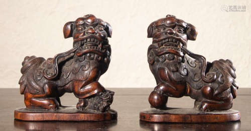 PAIR OF HUALI WOOD PAPERWEIGHT SHAPED WITH LION