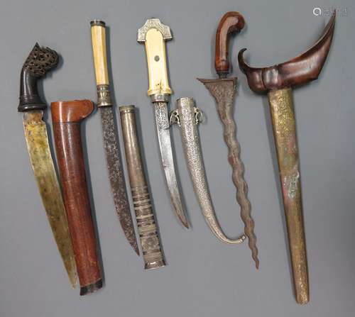 ˜A BURMESE DHA DAGGER, A MALAYSIAN DAGGER, A MALAYSIAN DAGGER, A NORTH AFRICAN DAGGER