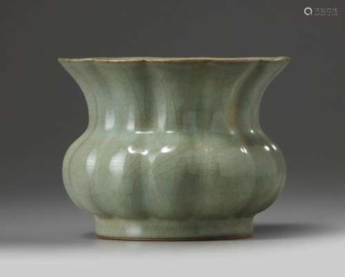 A CHINESE CELADON CRACKLE GLAZED FOLIATE SPITTOON,…