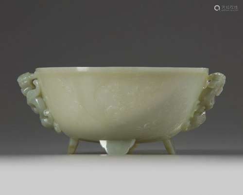 A CHINESE CELADON JADE 'POETIC' TWIN HANDLED BOWL,…