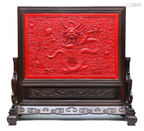 A RED LACQUER ZITAN WOOD SCREEN CARVED WITH DRAGON PATTERN