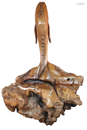 A burlwood carved whale sculpture