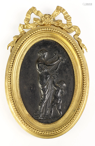 A framed cast iron mythological plaque