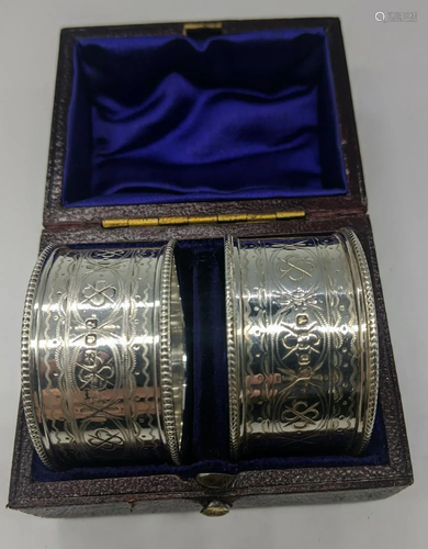 A pair of cased Victorian silver napkin rings,