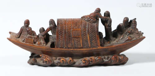 A TANXIANG WOOD CARVED FIGURE AND BOAT