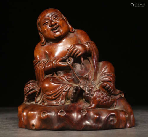 A HUANGYANG WOOD CARVED FIGURE