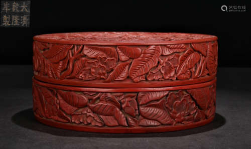 A RED LACQUER BOX CARVED WITH FLOWER