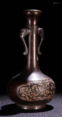 A COPPER VASE WITH ELEPHANT EARS