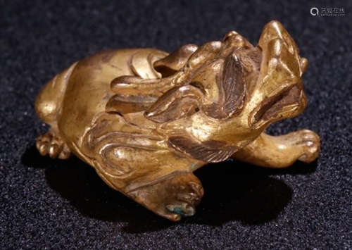 A GILT BRONZE PAPERWEIGHT WITH AUSPICIOUS BEAST