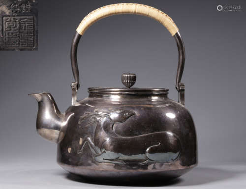 A SILVER POT WITH DRAGON