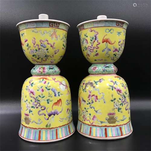 A pair of eight treasures candlesticks with yellow background