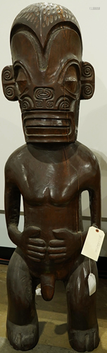 A decorative polynesian wood sculpture of a tiki