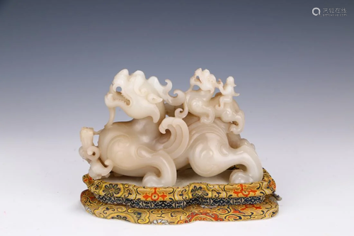 A CARVED JADE MYTHICAL BEAST ORNAMENT