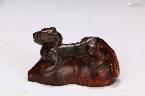 AN ARCHAIC JADE CARVING OF A MYTHICAL BE…