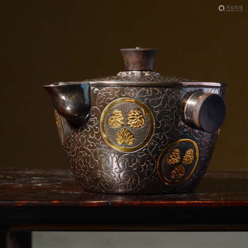 JAPANESE SHOWA PERIOD SILVER CAST AND GILT CARVED TEAPOT