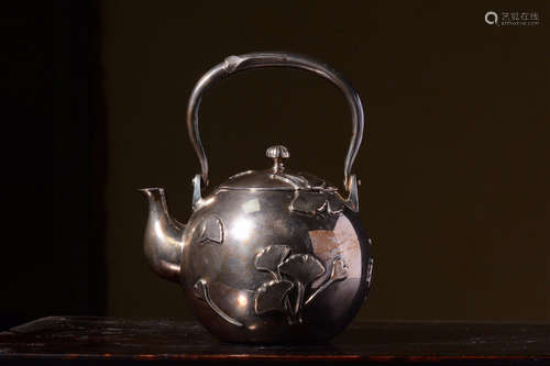 JAPANESE SHOWA PERIOD SILVER CAST AND CARVED TEAPOT WITH LIFTING HANDLE