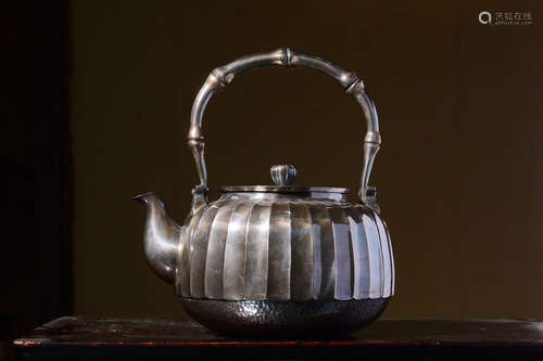 JAPANESE SHOWA PERIOD SILVER CAST AND LOBED TEAPOT WITH LIFTING HANDLE