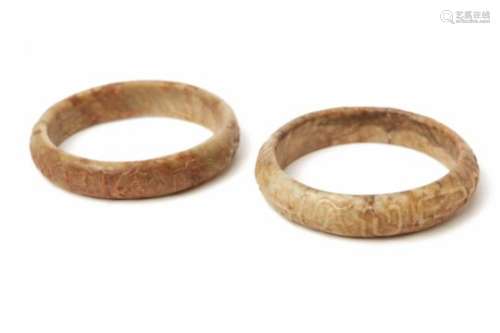 TWO CARVED JADE BANGLES