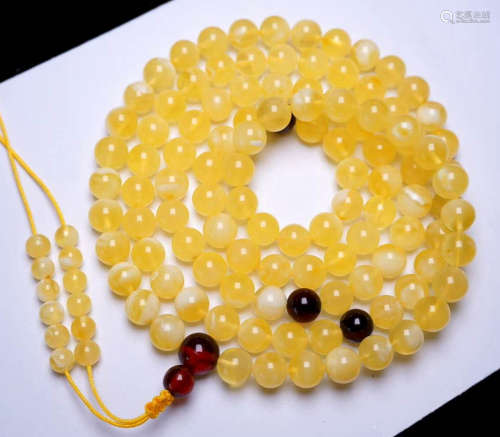 AN AMBER STRING NECKLACE WITH 108 BEADS