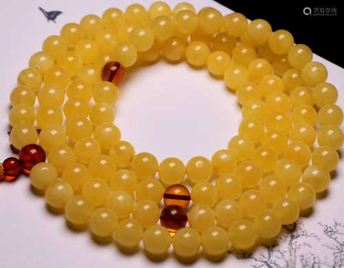 AN AMBER STRING NECKLACE WITH 108 BEADS