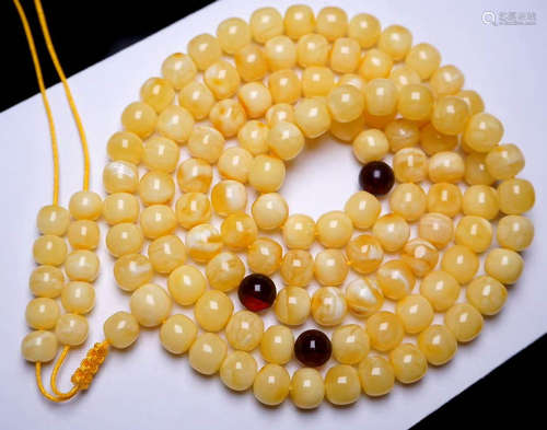 AN AMBER STRING NECKLACE WITH 108 BEADS