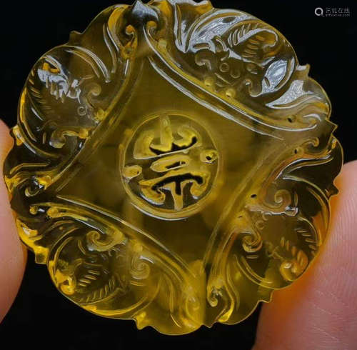 AN AMBER CARVED AUSPICIOUS PENDANT