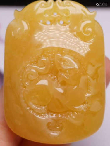 AN AMBER CARVED PENDANT