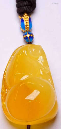 AN AMBER CARVED PENDANT