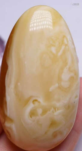 AN AMBER CARVED PENDANT