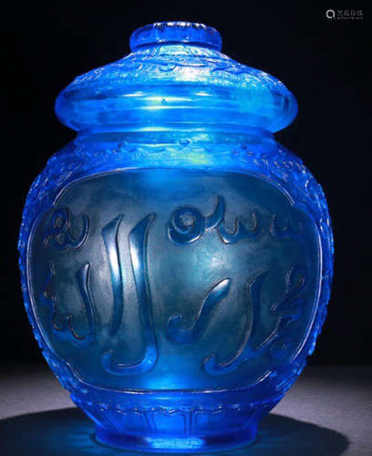 A GLASS CARVED JAR WITH SANSKRIT PATTERN