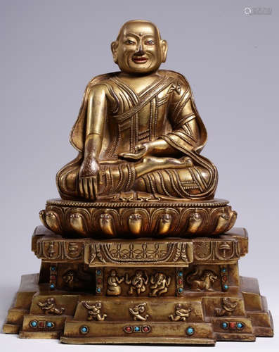 A GILT BRONZE WITH GEM DECORATED BUDDHA