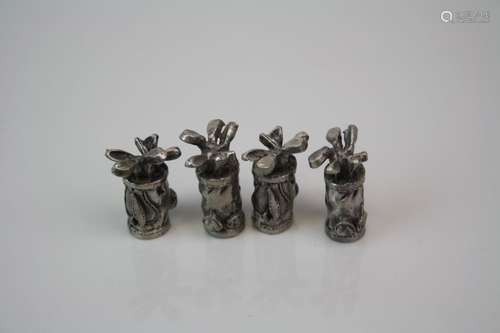 Set of four miniature pewter golf bags.