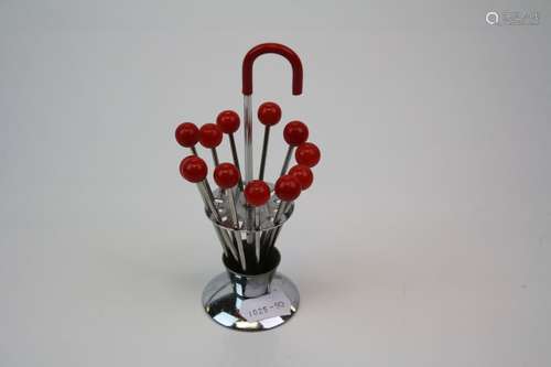 Set of Art Deco cocktail sticks in orginal stand in the form of an umbrella.