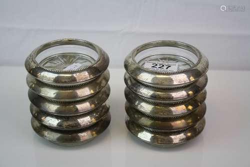 A set of 10 x glass coasters with white metal rims, rims marked Rank M. Whiting & Co, Sterling.