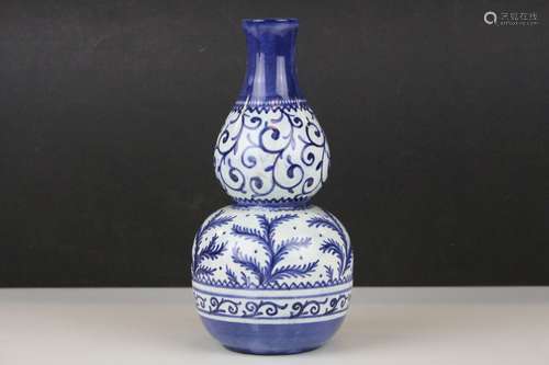 A blue and white double gourd vase with painted fern decoration