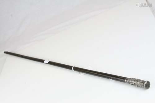 Early 20th century Swagger Stick, the white metal handle with embossed decoration of South East