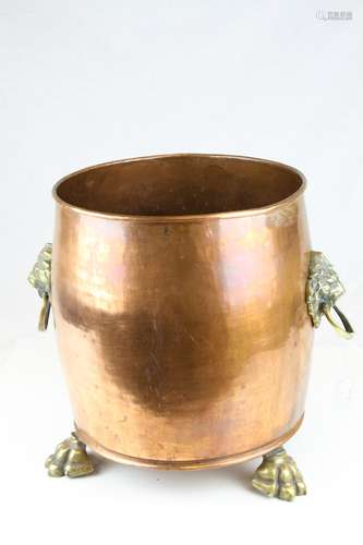 Large Copper Planter / Log Basket with Brass Lion Mask Ring Handles and raised on Three Brass Lion