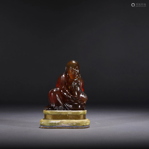 A CHINESE AMBER ARHAT STATUE