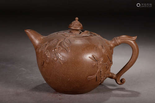 A Chinese Zisha Teapot with Plum Blossom Pattern