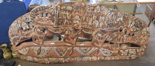 Large tribal art wooden carved panel of a village scene, decorated with tribesman in canoes,