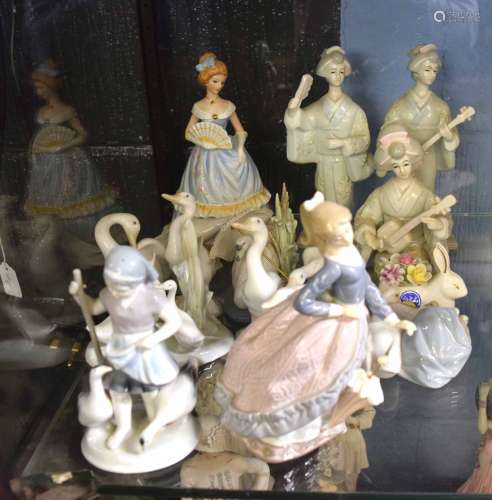 Group of Continental porcelain models of children in various poses, together with a model of two