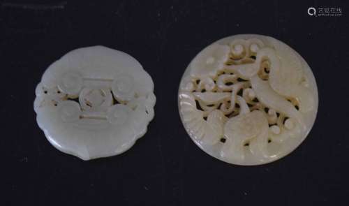 Two green jade medallions, one carved with birds, the other with a geometric design (2)