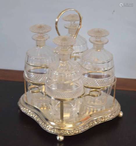 Silver plated set containing four small cut glass decanters with mushroom shaped stoppers (4),
