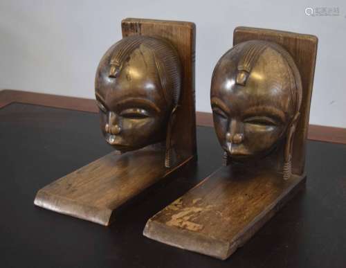 Pair of hardwood bookends with carvings of African heads
