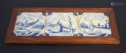 Three 18th century Delft tiles with blue and white designs of figures in landscapes, all within an