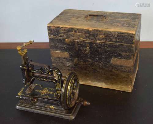 Early cast iron small sewing machine in an ebonised pine box, possibly Powell or Willcox & Gibbs,