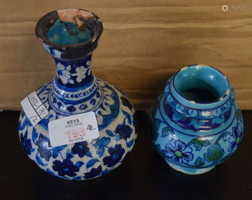 Two Persian Pottery vases with typical floral decoration on blue ground